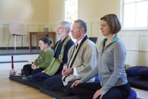 four people meditating