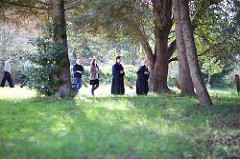 People in walking meditation with trees and grass.