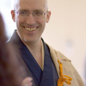Koshin, wearing his dress robes and smiling