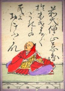 monk in robes meditating with Chines writing behind him