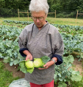 Zen Center member Shuko holding a cabbage for the food bank