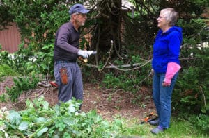 2 people working to tidy the Zen Center's grounds.