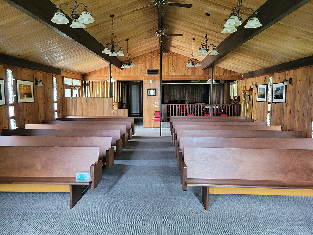 interior of our new home showing pews and wood paneling