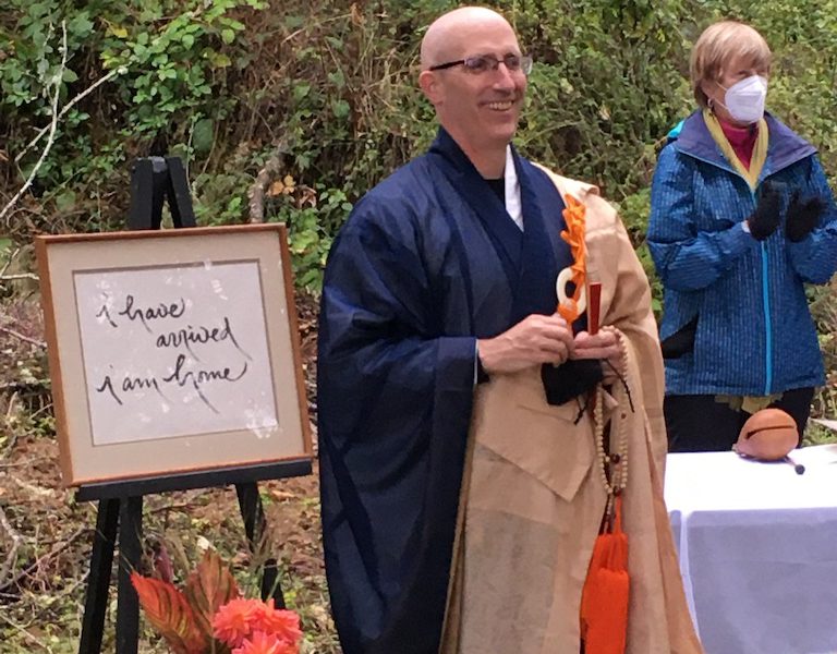 Koshin in Buddhist dress robes speaking at a celebration