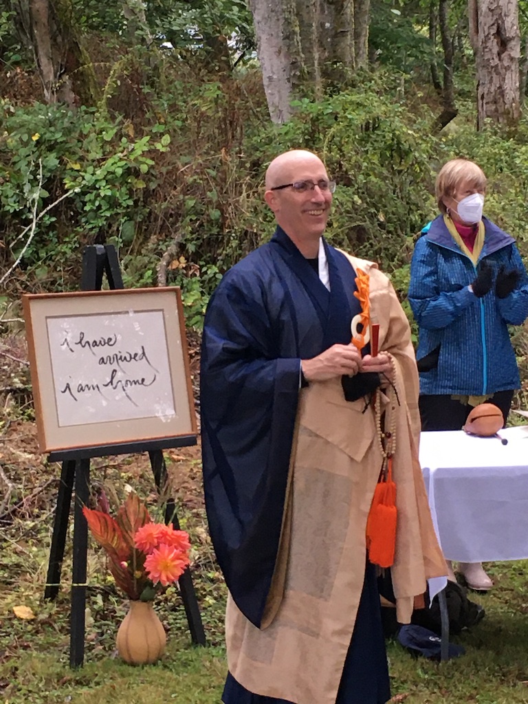 Koshin in Buddhist dress robes speaking at a celebration