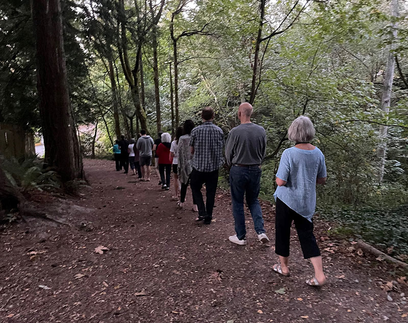 sangha members practicing walking meditation in a forest in West Seattle