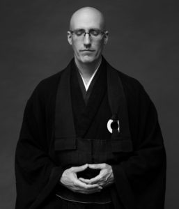 Black and white picture of Koshin in meditation posture.